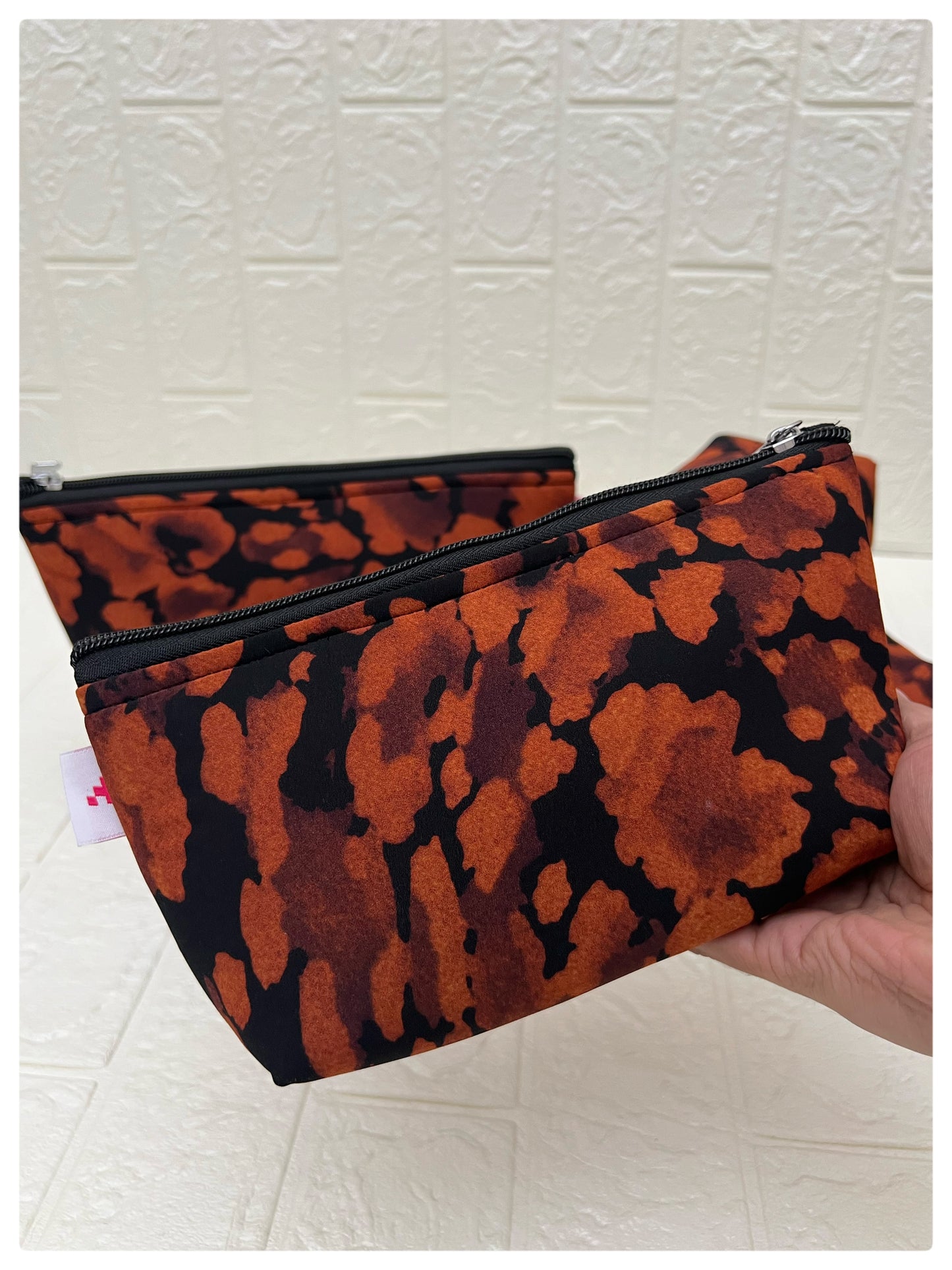 BLACK-ORANGE ABSTRACT POUCHES