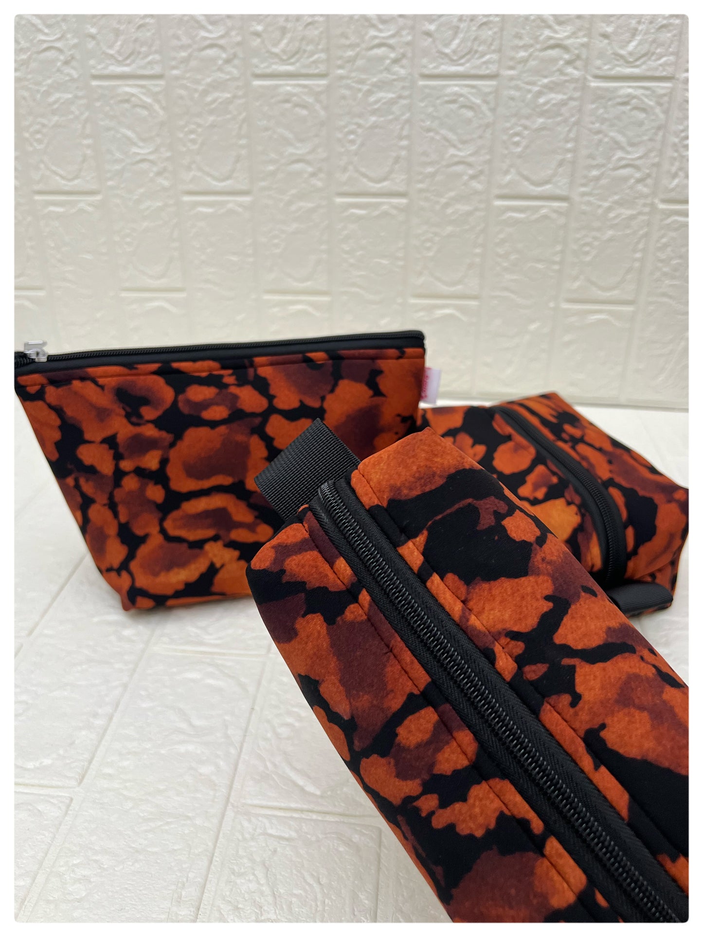 BLACK-ORANGE ABSTRACT POUCHES
