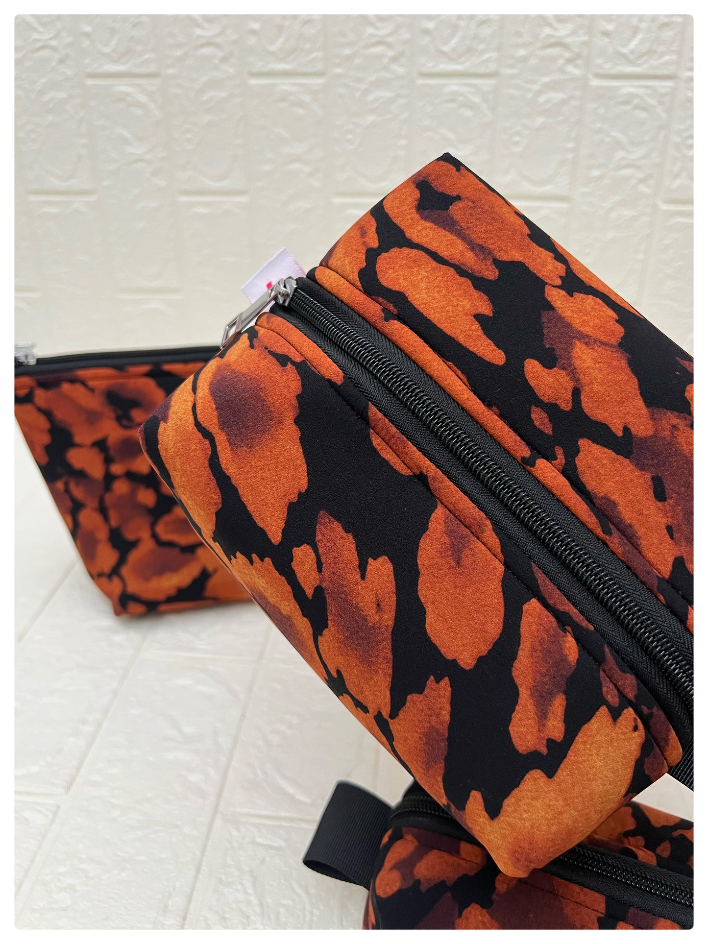 BLACK-ORANGE ABSTRACT POUCHES